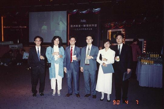Betty (second from right) with her husband on her left pictured before the live broadcast of AsiaSat 1 launch at HKCEC on 7 April 1990